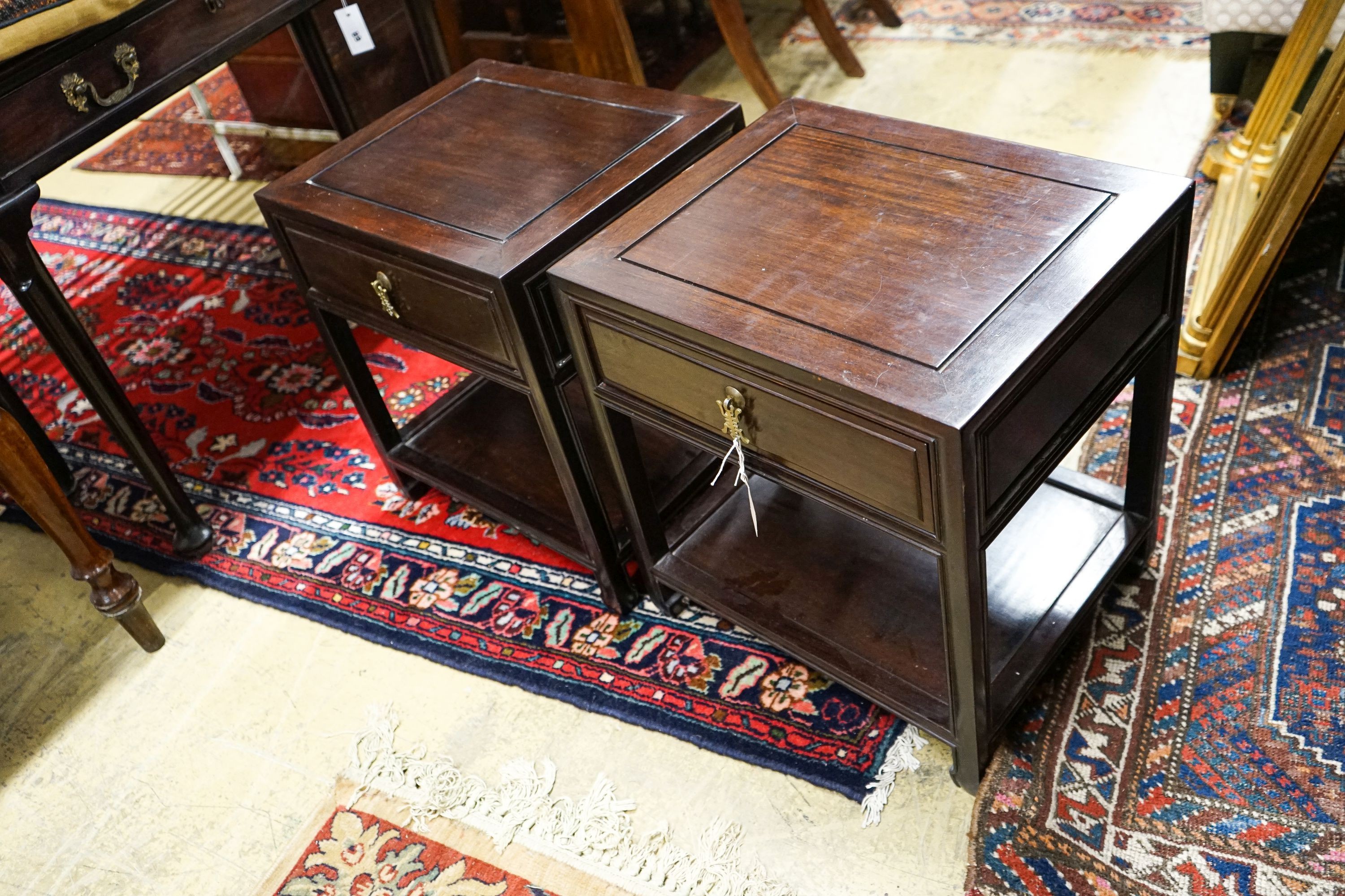 A pair of Chinese hardwood bedside tables, width 46cm, depth 38cm, height 51cm